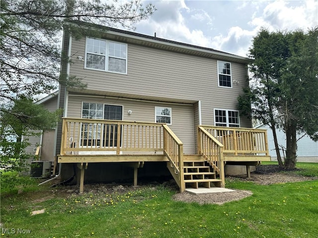 back of house with a wooden deck, cooling unit, and a yard