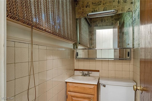 1056 Garman Rd, Akron, OH 44313 - half bath with tile walls, toilet, vanity, and backsplash