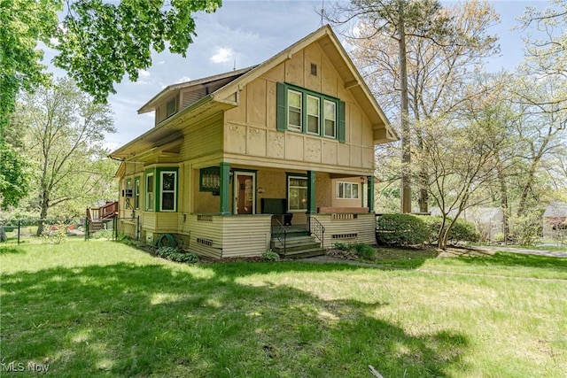 1056 Garman Rd, Akron, OH 44313 - back of property featuring covered porch, a lawn, and board and batten siding