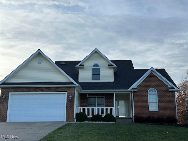 1245 Sageberry Dr, North Lima, OH 44452 - traditional-style home featuring a porch, brick siding, a front yard, concrete driveway, and a garage