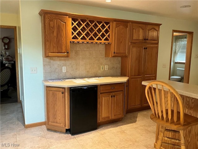 1245 Sageberry Dr, North Lima, OH 44452 - kitchen with light countertops, dishwasher, backsplash, brown cabinets, and recessed lighting