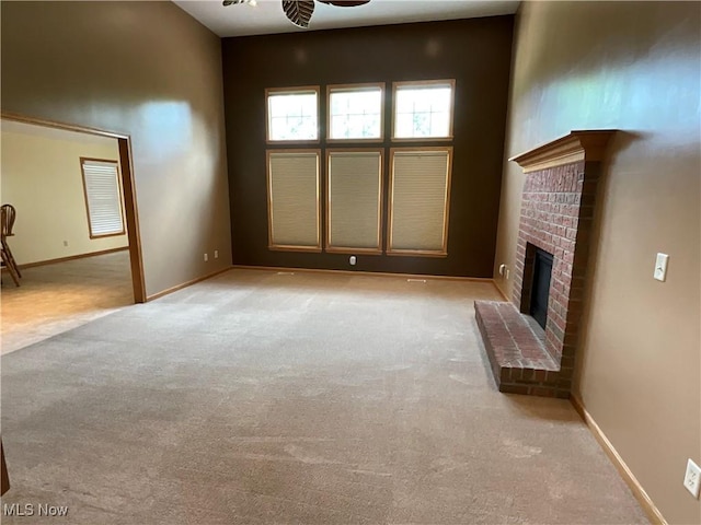 1245 Sageberry Dr, North Lima, OH 44452 - unfurnished living room with light carpet, a fireplace, and a ceiling fan