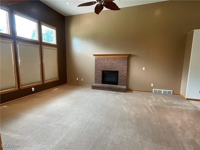 1245 Sageberry Dr, North Lima, OH 44452 - unfurnished living room with ceiling fan, light carpet, and a brick fireplace