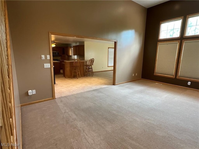 1245 Sageberry Dr, North Lima, OH 44452 - unfurnished room featuring light carpet, a ceiling fan, and a high ceiling