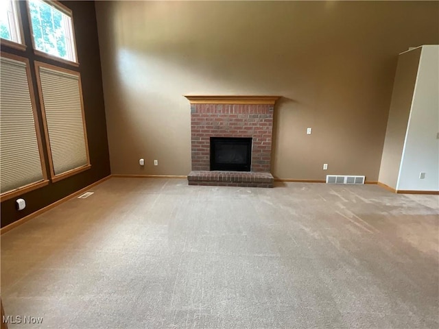 1245 Sageberry Dr, North Lima, OH 44452 - unfurnished living room with carpet, a brick fireplace, and a towering ceiling