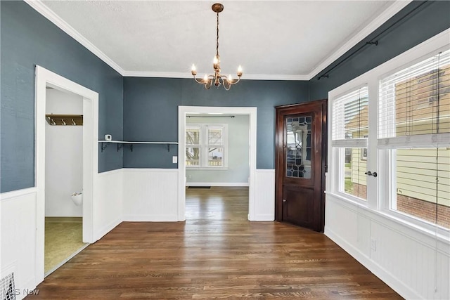 7700 Spring Garden Rd, Parma, OH 44129 - unfurnished dining area featuring a chandelier, wood finished floors, wainscoting, and crown molding