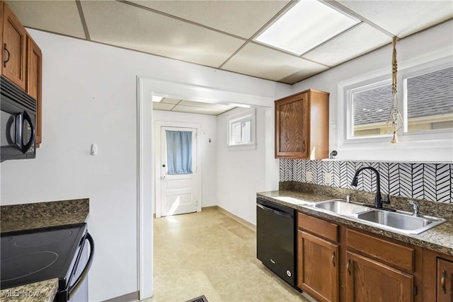 7700 Spring Garden Rd, Parma, OH 44129 - kitchen with black appliances, a sink, backsplash, and dark countertops
