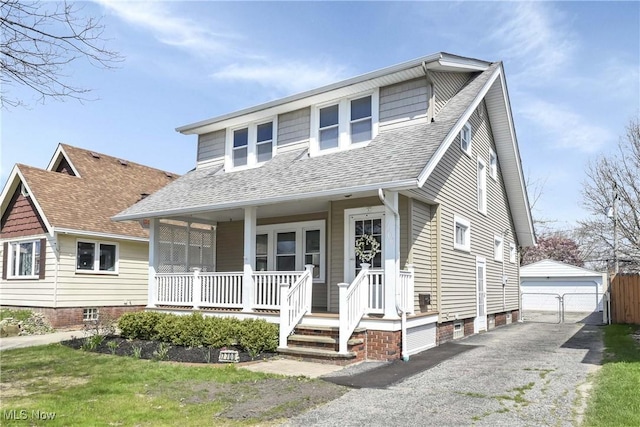 7700 Spring Garden Rd, Parma, OH 44129 - view of front of property with roof with shingles, covered porch, an outdoor structure, and a garage