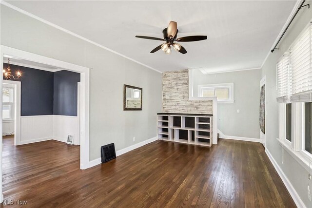 7700 Spring Garden Rd, Parma, OH 44129 - unfurnished living room featuring ornamental molding, wood finished floors, a ceiling fan, and healthy amount of natural light