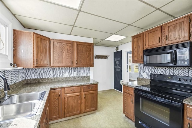 7700 Spring Garden Rd, Parma, OH 44129 - kitchen with black appliances, a sink, a paneled ceiling, backsplash, and light flooring