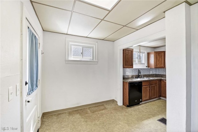 7700 Spring Garden Rd, Parma, OH 44129 - kitchen with a sink, dishwasher, light carpet, dark countertops, and backsplash
