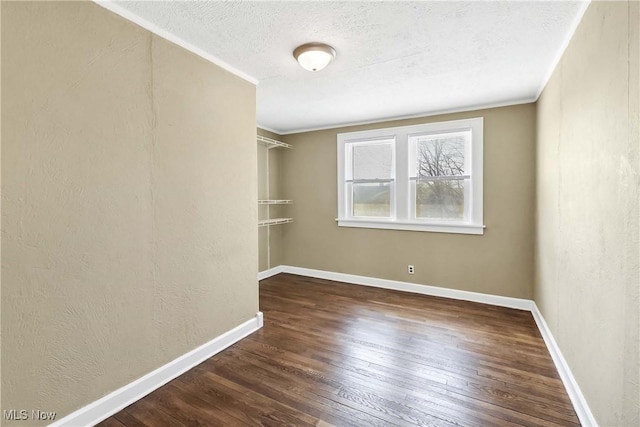 7700 Spring Garden Rd, Parma, OH 44129 - spare room featuring wood-type flooring, a textured ceiling, baseboards, and crown molding