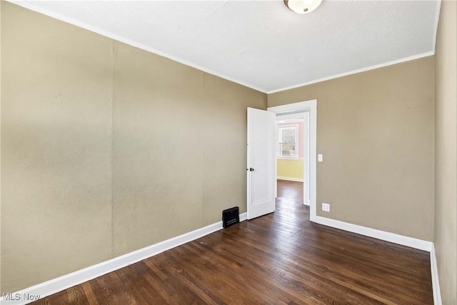 7700 Spring Garden Rd, Parma, OH 44129 - unfurnished room with dark wood-style flooring, baseboards, and crown molding