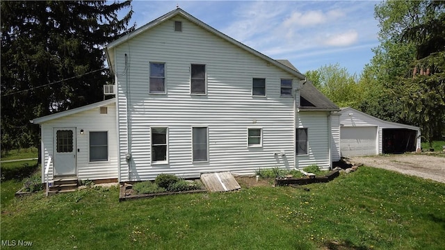 15561 Georgetown St NE, Minerva, OH 44657 - back of property featuring a yard, an outbuilding, entry steps, and a garage