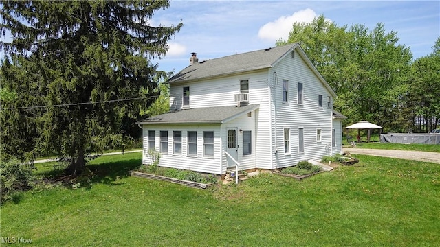 15561 Georgetown St NE, Minerva, OH 44657 - view of home's exterior featuring a chimney and a lawn
