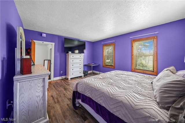 15561 Georgetown St NE, Minerva, OH 44657 - bedroom with a textured ceiling, dark wood-type flooring, and baseboards