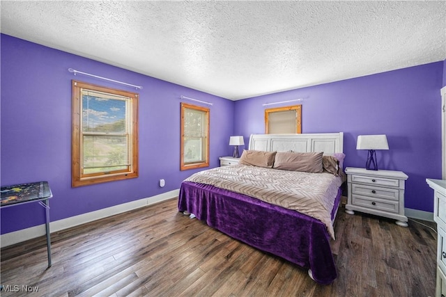 15561 Georgetown St NE, Minerva, OH 44657 - bedroom with a textured ceiling, baseboards, and wood finished floors