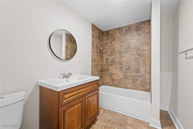 bathroom featuring bathtub / shower combination, vanity, and toilet