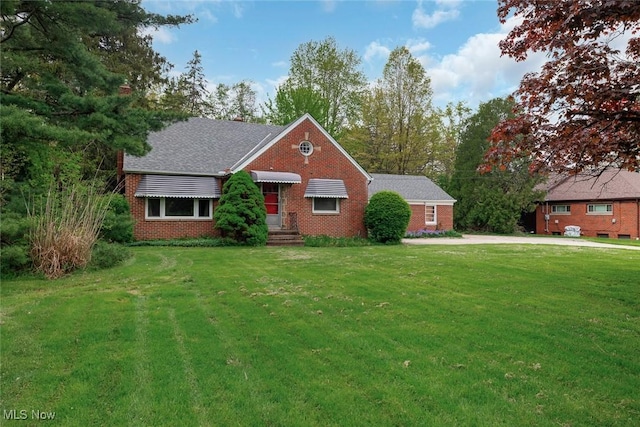 6119 E Sprague Rd, Independence, OH 44131 - view of front of house featuring brick siding and a front lawn