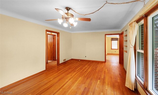 6119 E Sprague Rd, Independence, OH 44131 - spare room with light wood-style floors, ceiling fan, and baseboards