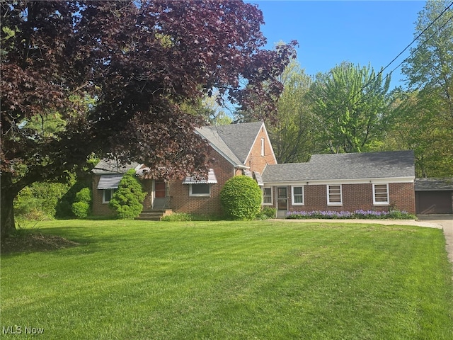 6119 E Sprague Rd, Independence, OH 44131 - view of front facade featuring a front lawn, brick siding, and a garage