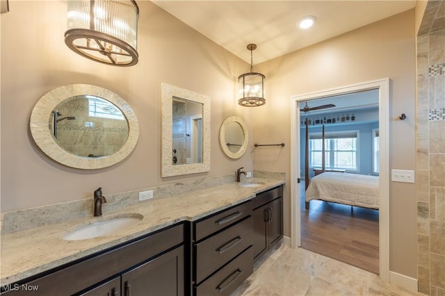 full bath with double vanity, connected bathroom, and tiled shower