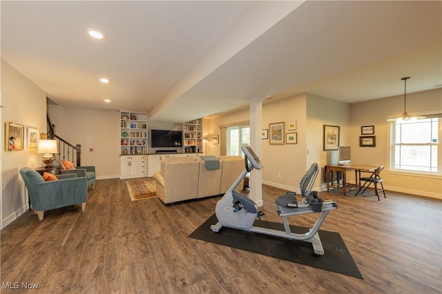 workout room with baseboards, dark wood-type flooring, recessed lighting, and built in features