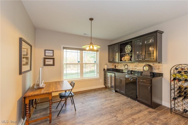 indoor wet bar featuring dishwasher, wine cooler, backsplash, and dark wood finished floors