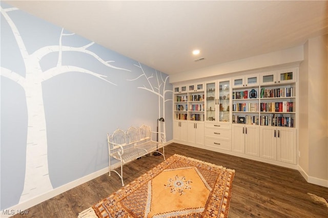 sitting room featuring dark wood finished floors and baseboards
