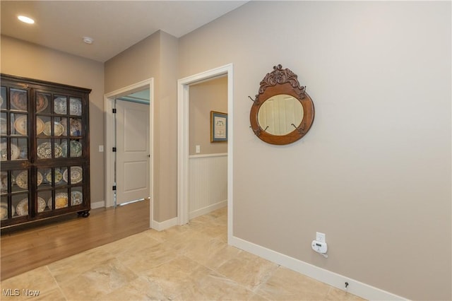 hall featuring baseboards