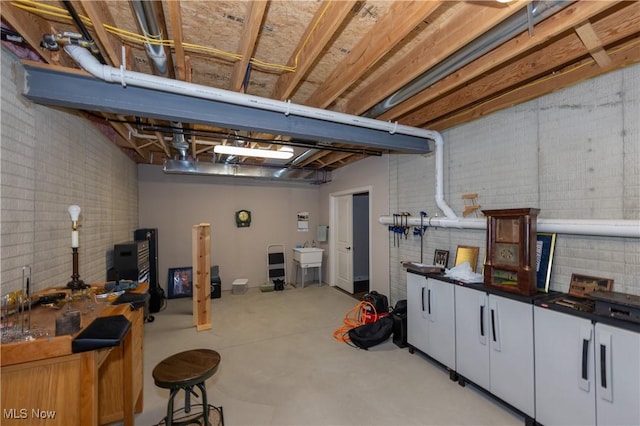 unfinished below grade area with brick wall and a sink