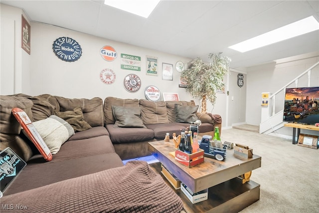 living room featuring carpet and stairs