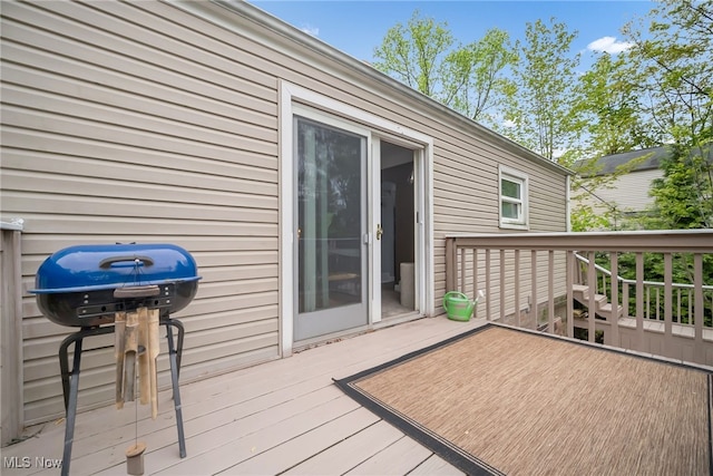 wooden deck featuring a grill