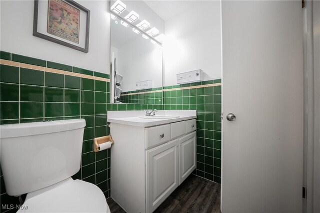 24660 Sittingbourne Ln, Beachwood, OH 44122 - bathroom featuring tile walls, toilet, vanity, wood finished floors, and wainscoting