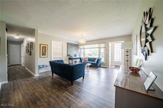 24660 Sittingbourne Ln, Beachwood, OH 44122 - living room featuring dark wood-type flooring, baseboards, and a textured ceiling