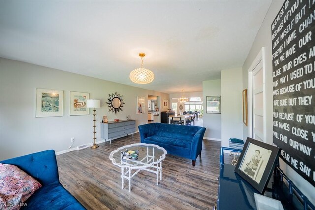 24660 Sittingbourne Ln, Beachwood, OH 44122 - living area with a chandelier, wood finished floors, and baseboards