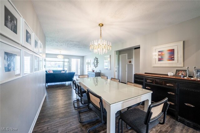 24660 Sittingbourne Ln, Beachwood, OH 44122 - dining space featuring dark wood-style floors, a chandelier, baseboards, and a textured ceiling
