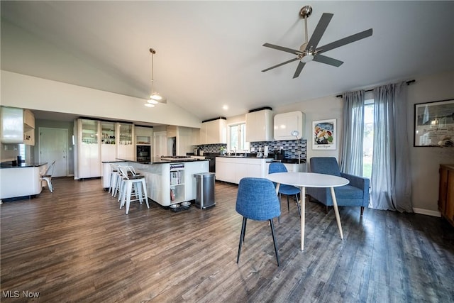 24660 Sittingbourne Ln, Beachwood, OH 44122 - dining space with vaulted ceiling, healthy amount of natural light, dark wood-style floors, and ceiling fan
