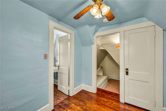 bonus room with lofted ceiling, dark wood-type flooring, a ceiling fan, and baseboards