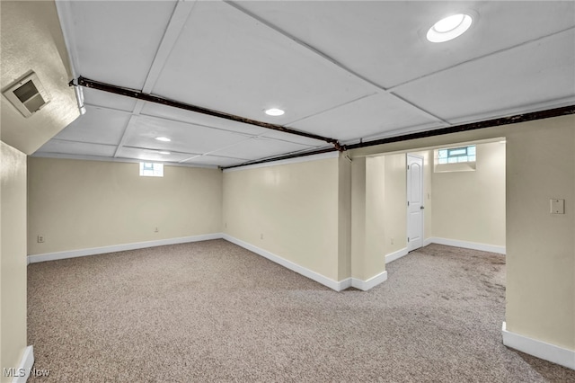 below grade area featuring carpet floors, baseboards, and recessed lighting