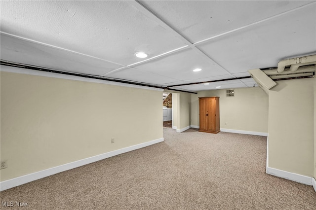finished below grade area with recessed lighting, light carpet, and baseboards