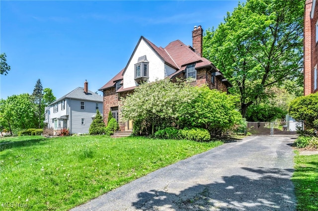 view of front of house with a chimney and brick siding