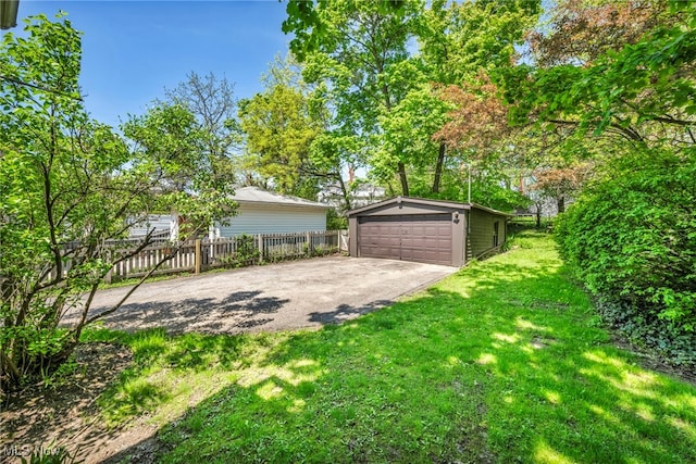 view of yard featuring an outbuilding and a detached garage
