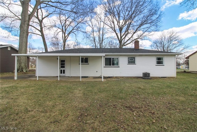 1674 Yolanda Dr, Austintown, OH 44511 - back of property featuring central AC, a yard, a chimney, a carport, and a patio