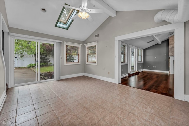 unfurnished living room featuring ceiling fan, a skylight, baseboards, tile patterned floors, and a baseboard heating unit