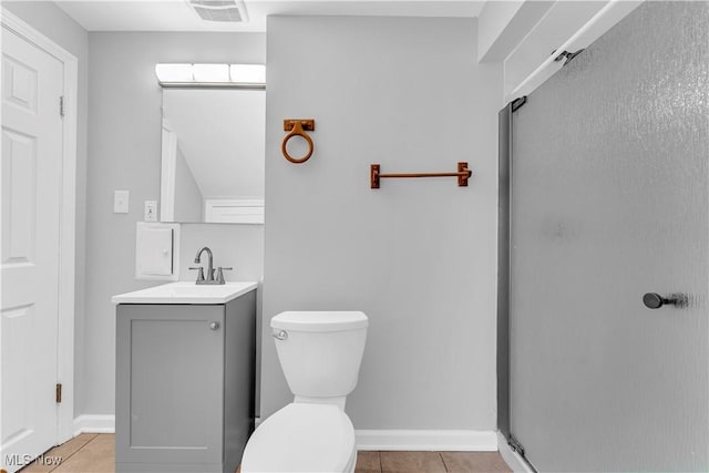 full bath featuring tile patterned flooring, vanity, toilet, and baseboards