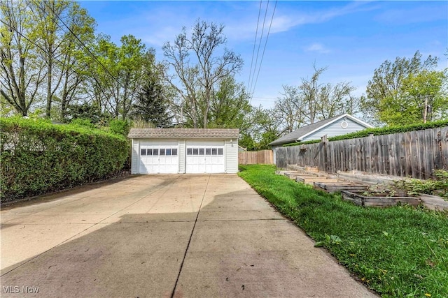detached garage featuring fence