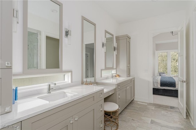 full bathroom with vanity, connected bathroom, and baseboards
