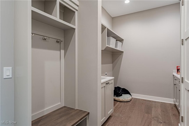 mudroom featuring wood finished floors, recessed lighting, and baseboards