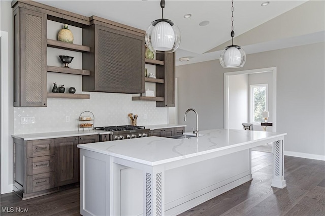 kitchen with open shelves, a sink, stainless steel gas stovetop, lofted ceiling, and decorative backsplash